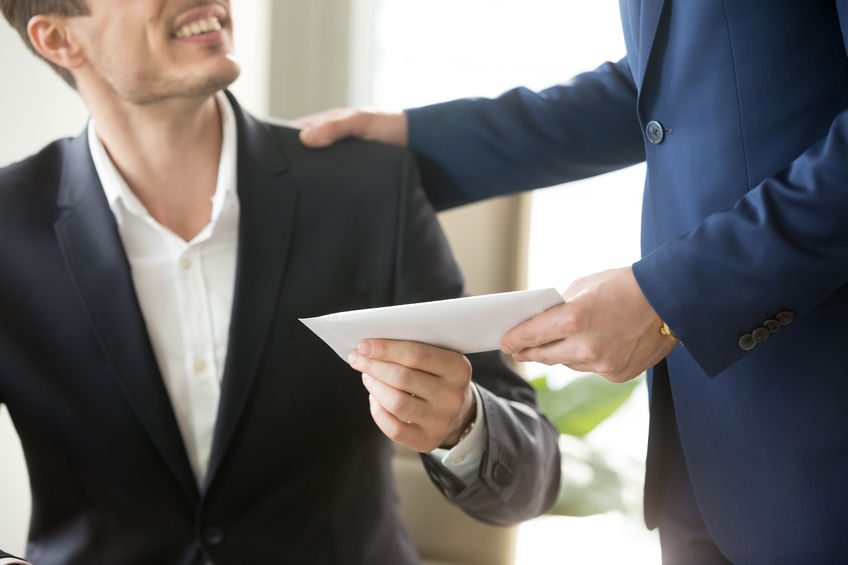 company leader giving money bonus in paper envelope to happy smiling office worker, congratulating employee with increasing of salary or promotion, thanking for successes in work. close up concept