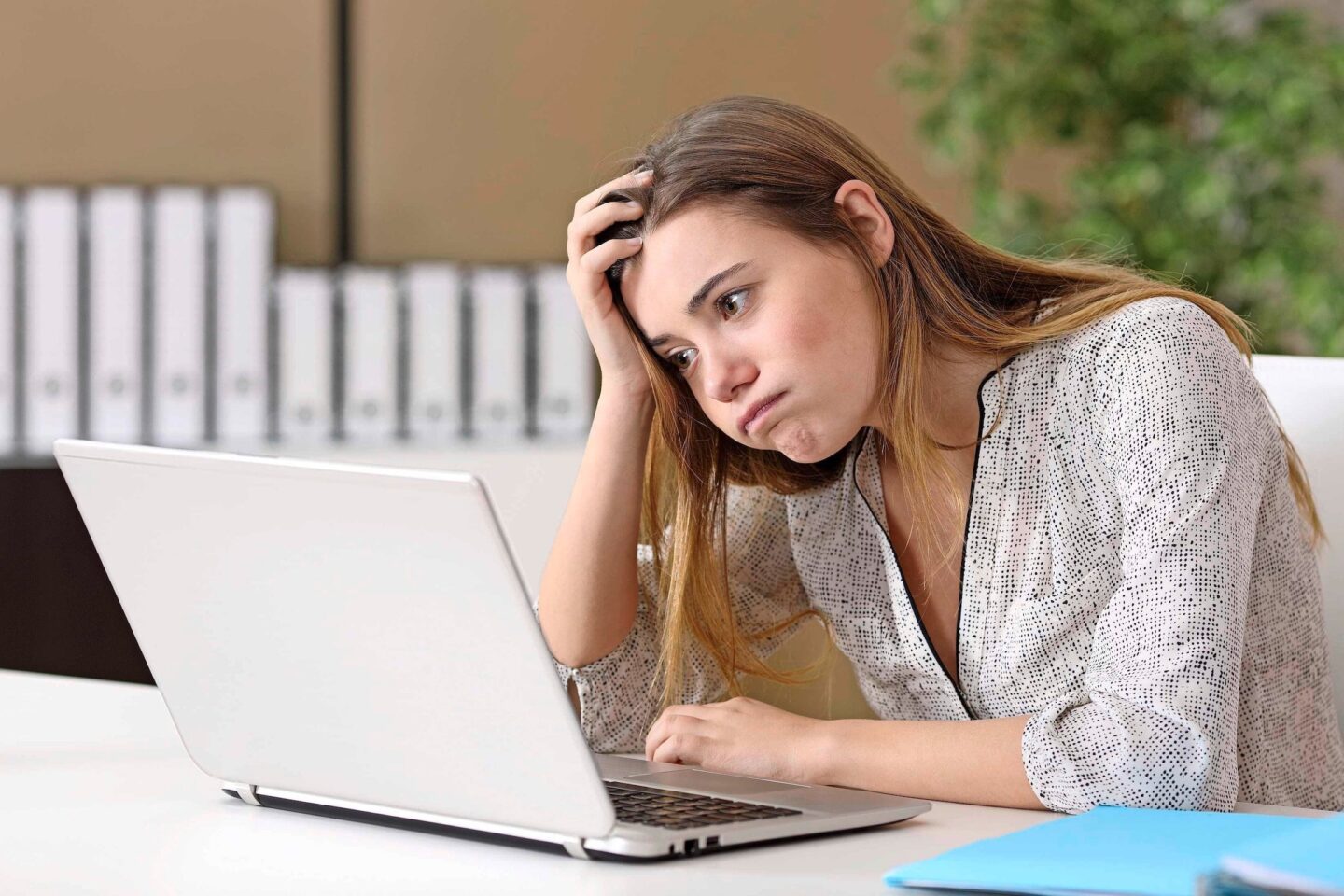 Frustrated intern working on line at office