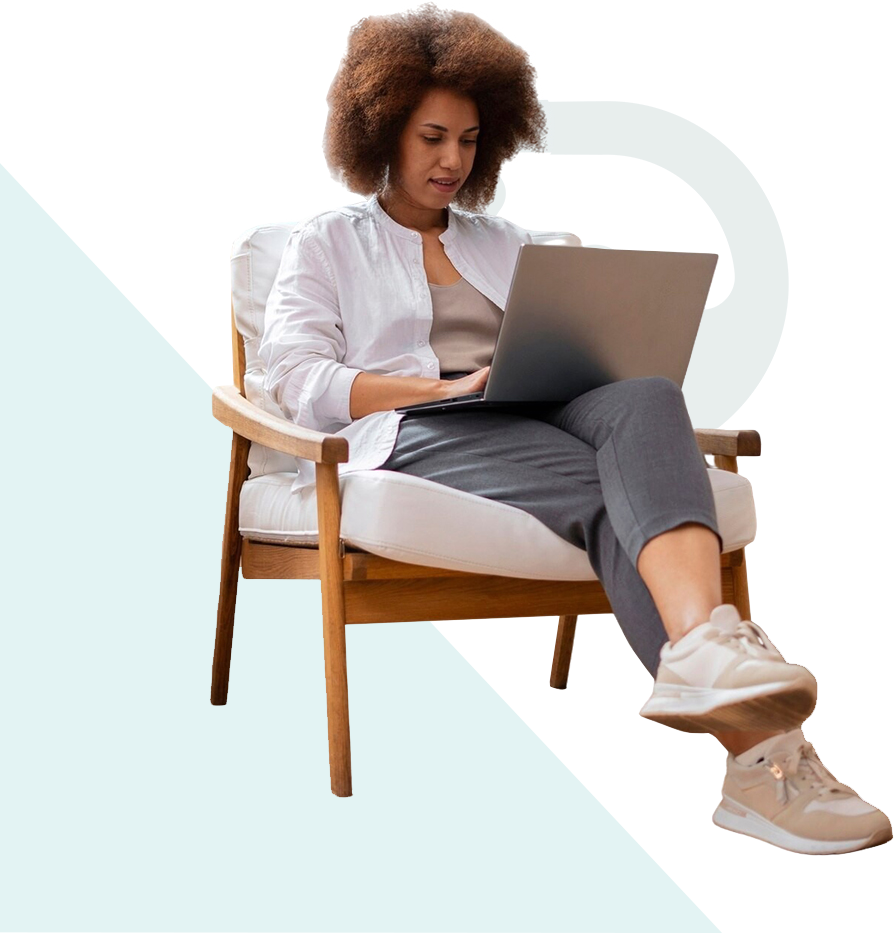 A woman sitting comfortably on a chair using a laptop.