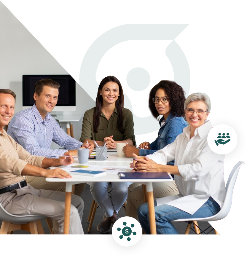 Five smiling professionals are seated around a white table in a meeting.