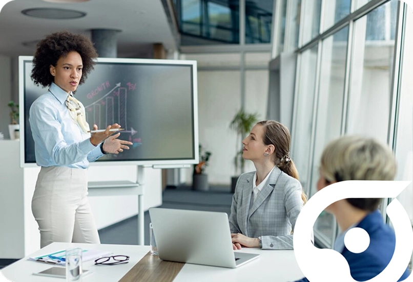 Business professionals in a modern office meeting discussing presentation with digital screen