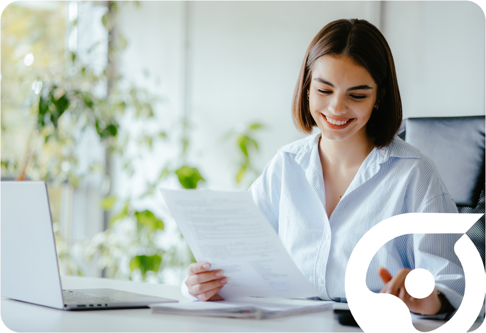 a smiling woman holding a piece of paper and doing some calculations on a calculator